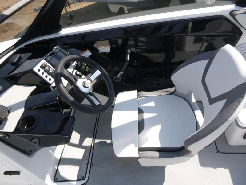 Slide: The Image of 2025 Yamaha Boats AR220 cockpit with steering wheel and modern seating design. - 5