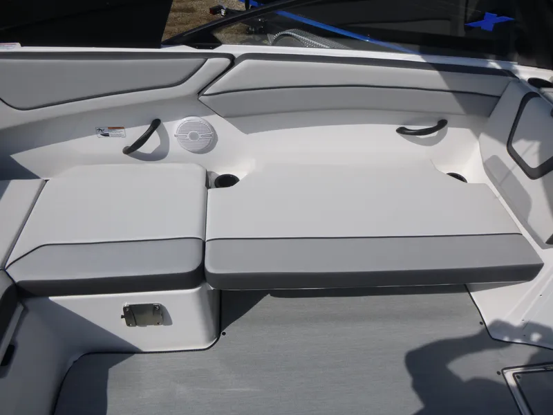 Slide: The Image of 2025 Yamaha Boats AR220 interior seating with gray cushions and sleek design. - 7