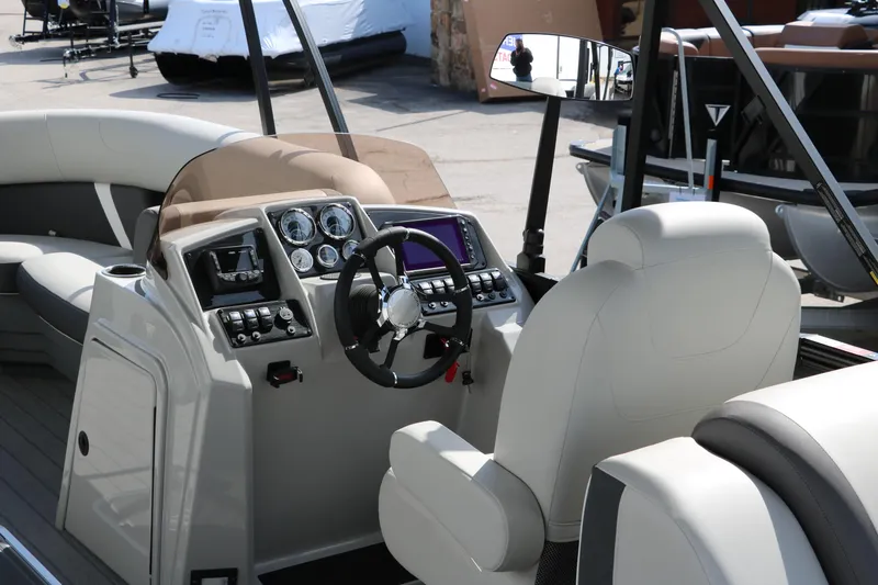 Slide: The Image of 2025 Sylvan Mirage X3 boat interior with modern dashboard and steering wheel. - 19