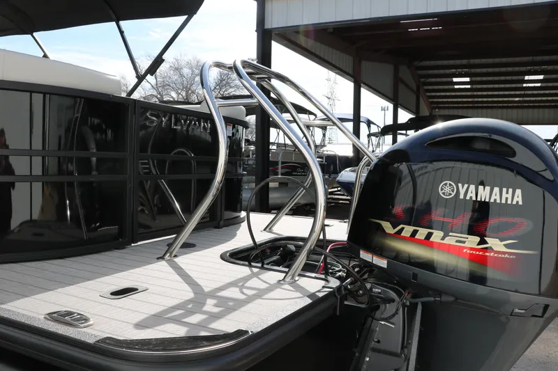Slide: The Image of 2025 Sylvan Mirage X3 pontoon boat with Yamaha VMAX engine, docked under shelter. - 4