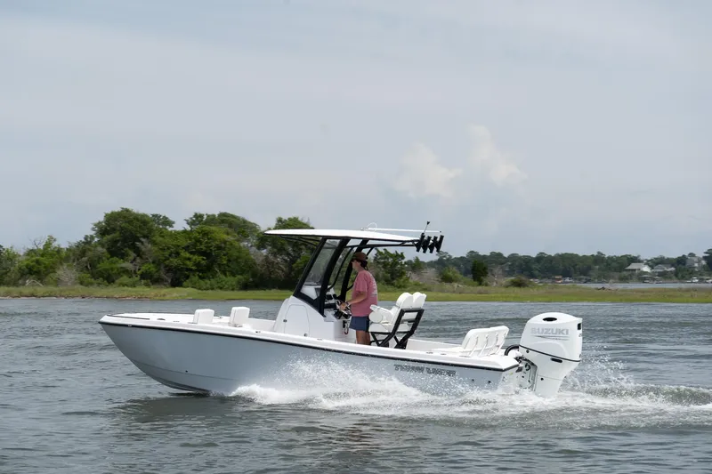 Slide: The Image of 2026 Twin Vee 22 Baycat cruising on water with Suzuki outboard motor. - 10