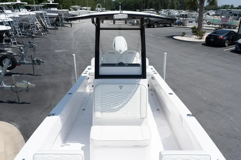 Slide: The Image of 2026 Twin Vee 22 Baycat boat at a dealership, showcasing sleek design and spacious deck. - 25