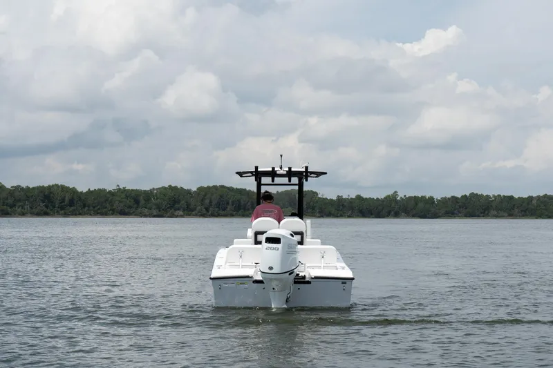Slide: The Image of 2026 Twin Vee 22 Baycat boat on calm water under cloudy sky. - 7