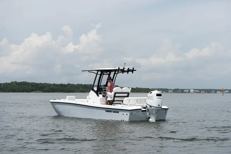 Slide: The Image of 2026 Twin Vee 22 Baycat boat on calm water, overcast sky in the background. - 9