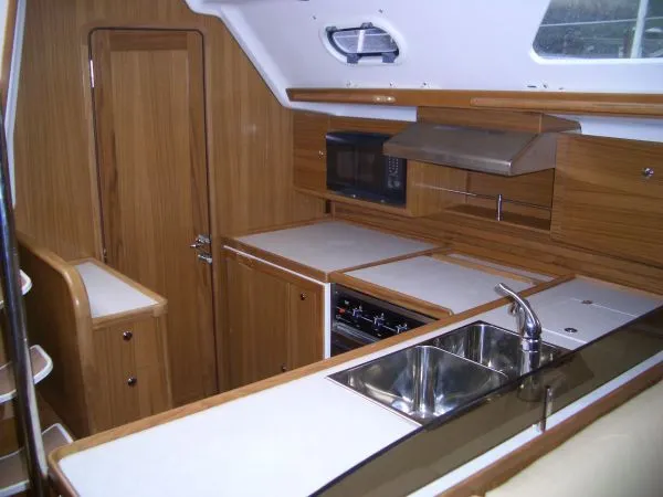 Slide: The Image of Modern kitchen interior of 2026 Catalina 446 yacht with wood finish and stainless steel sink. - 10