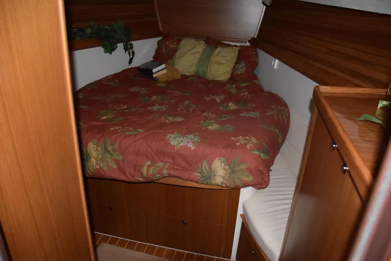 Slide: The Image of Cozy cabin interior of 2026 Catalina 446 yacht with floral bedding and wooden furnishings. - 13