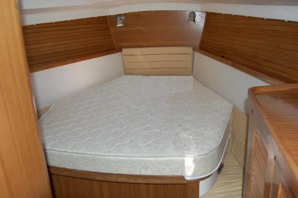 Slide: The Image of Cozy cabin interior of 2026 Catalina 446 yacht with wooden paneling and comfortable bedding. - 14