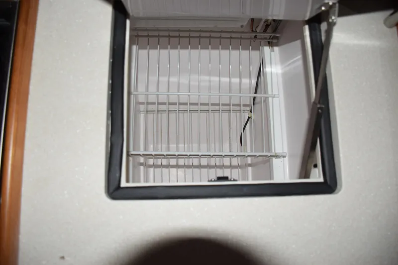 Slide: The Image of Open refrigerator compartment in a 2026 Catalina 446 model yacht. - 15