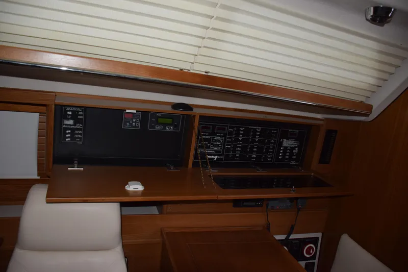 Slide: The Image of Interior view of a 2026 Catalina 446 yacht control panel with wooden finish. - 16
