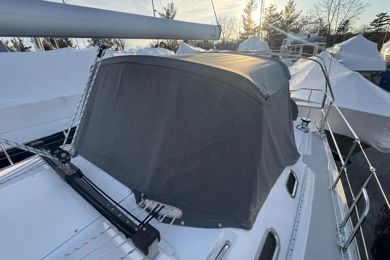 Slide: The Image of Sailboat Catalina 446, 2026 model, with covered cockpit and sleek design, docked outdoors. - 25