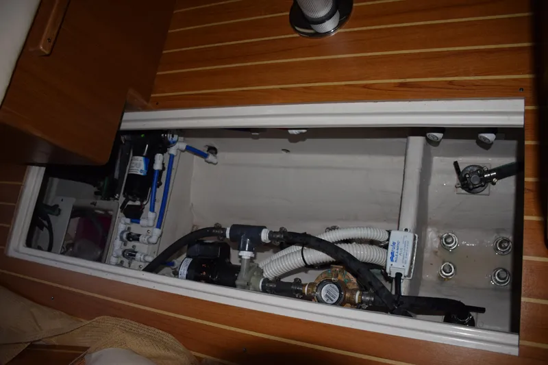 Slide: The Image of Interior view of Catalina 446 yacht's mechanical compartment, showcasing plumbing and equipment, 2026 model. - 28