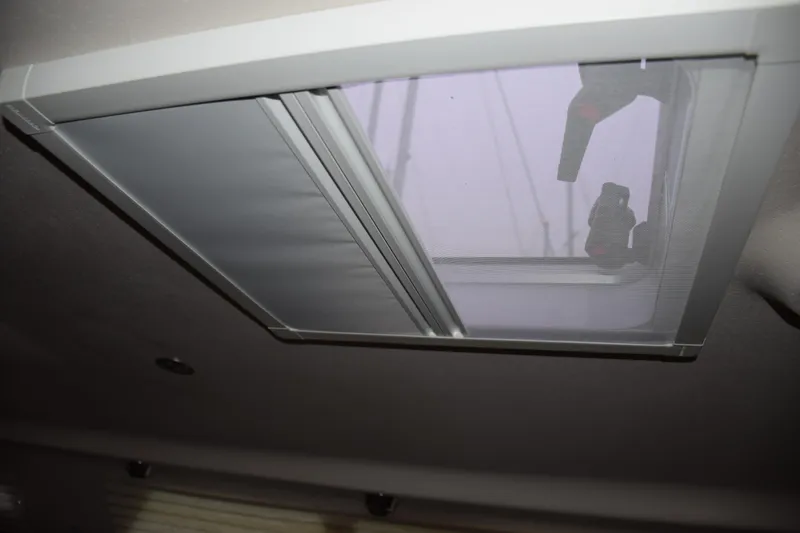 Slide: The Image of Ceiling hatch of 2026 Catalina 446 yacht with screen and shade. - 29