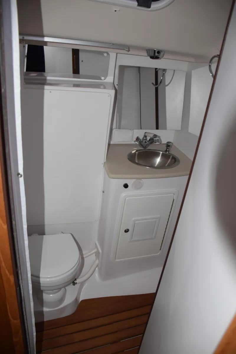 Slide: The Image of 2026 Catalina 446 yacht bathroom with sink, toilet, and wooden flooring. - 30