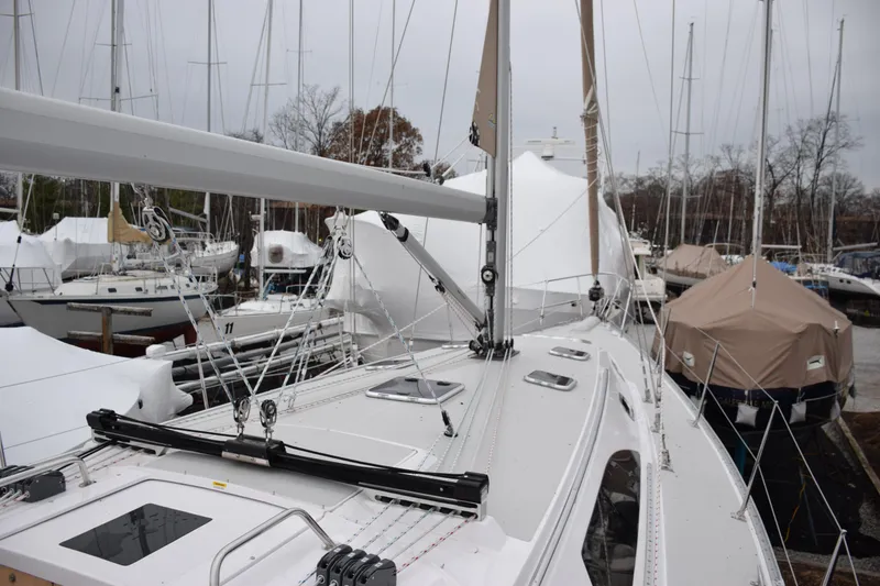 Slide: The Image of Sailboat Catalina 446, 2026 model, docked with covered boats in marina background. - 31