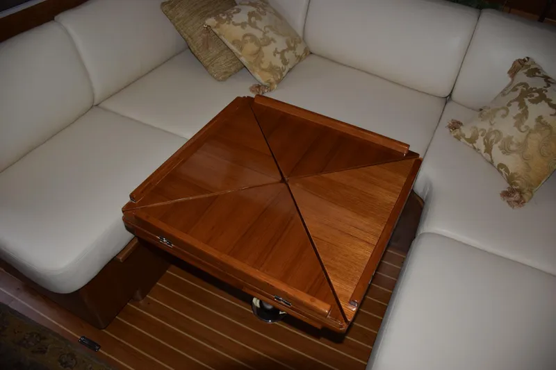 Slide: The Image of Luxurious Catalina 446 yacht interior with elegant wooden table and plush white seating, 2026 model. - 5