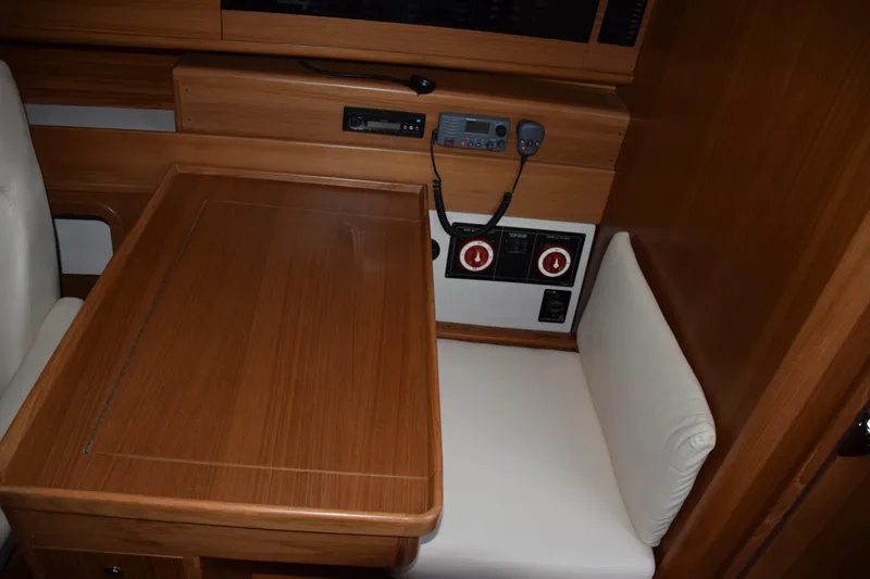 Slide: The Image of 2026 Catalina 446 yacht interior with wooden table and cushioned seating. - 9