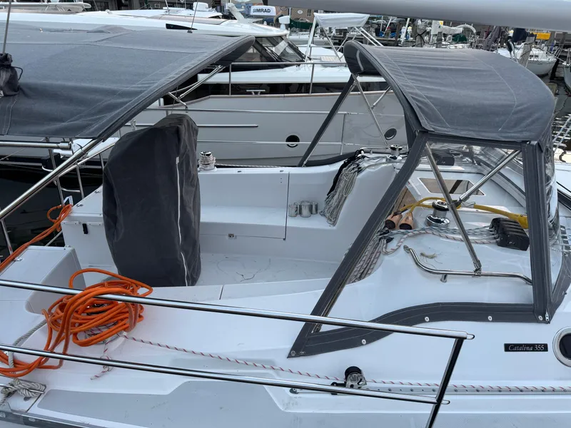 Slide: The Image of 2026 Catalina 356 sailboat cockpit with canopy and orange rope, docked at marina. - 32