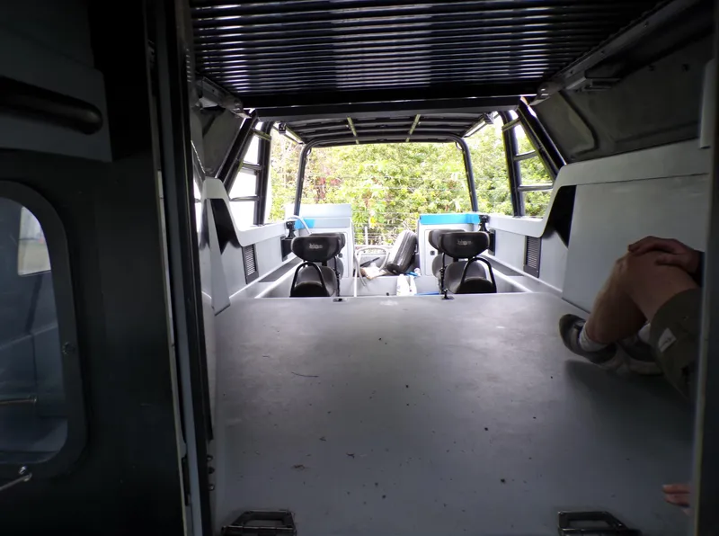 Slide: The Image of Interior view of a 2001 Custom Revenge 50 vehicle, showcasing spacious seating and modern design. - 12