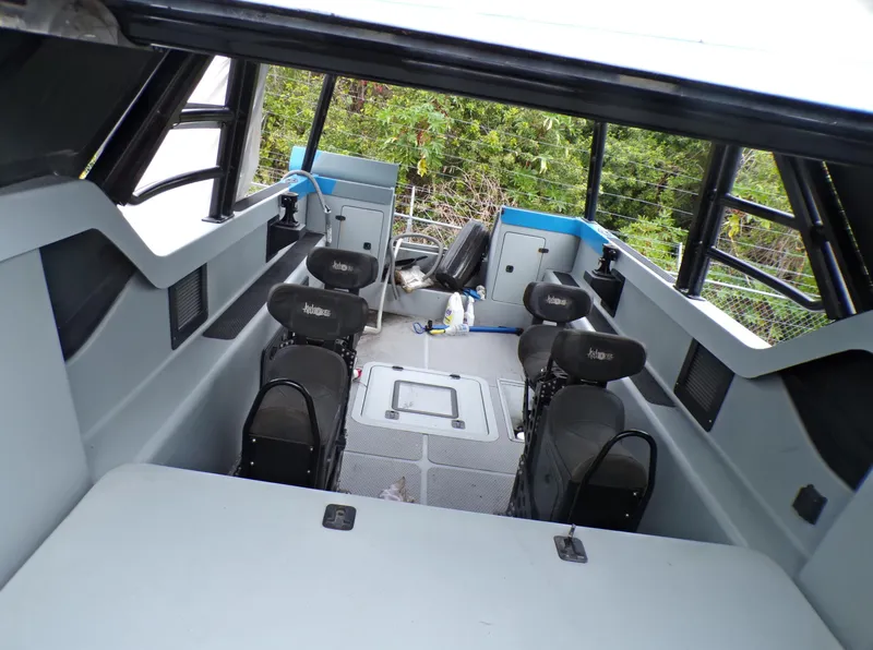 Slide: The Image of Interior of a 2001 Custom Revenge 50 boat with seating and storage compartments. - 14