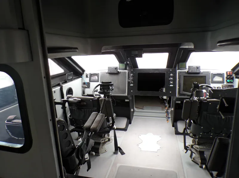 Slide: The Image of Interior cockpit of a 2001 Custom Revenge 50 boat, featuring advanced navigation equipment. - 16