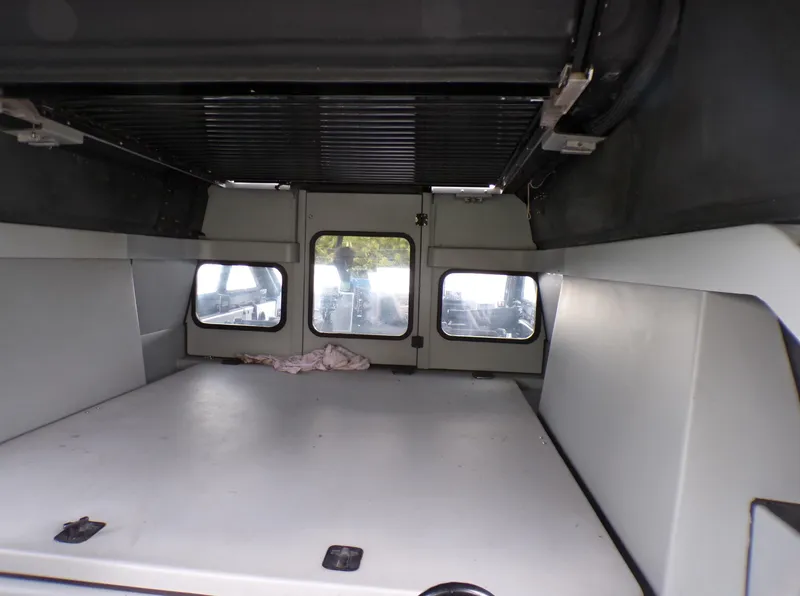 Slide: The Image of Interior of a 2001 Custom Revenge 50 vehicle, featuring spacious cargo area. - 18