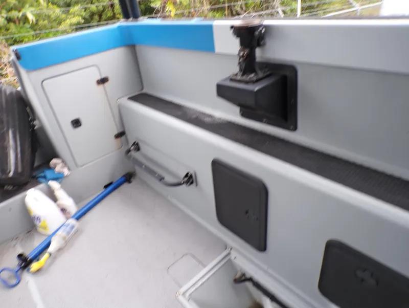 Slide: The Image of Interior of a 2001 Custom Revenge 50 boat, featuring storage compartments and equipment. - 19