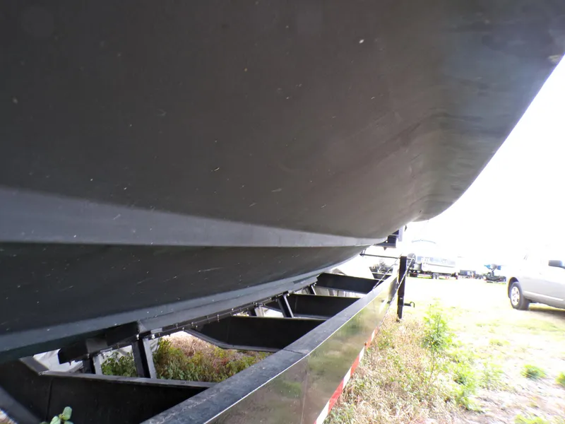 Slide: The Image of Underneath view of a 2001 Custom Revenge 50 boat on a trailer. - 22