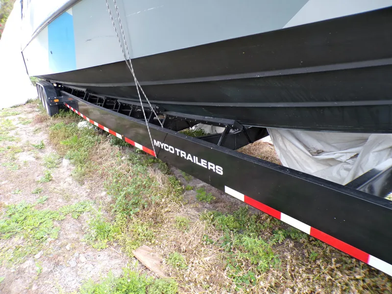 Slide: The Image of Custom Revenge 50 boat on Myco trailer, side view, parked on grass. - 24