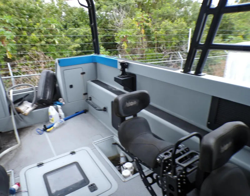 Slide: The Image of Interior of a 2001 Custom Revenge 50 boat with seating and storage compartments. - 3