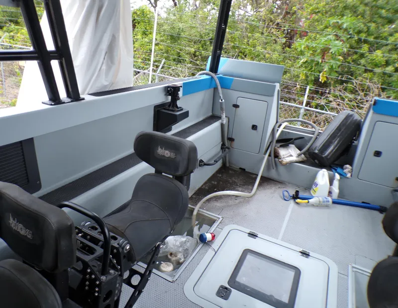 Slide: The Image of Interior of a 2001 Custom Revenge 50 boat with seating and storage compartments. - 4