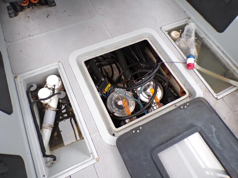 Slide: The Image of Engine compartment of a 2001 Custom Revenge 50 boat, showing mechanical components and wiring. - 5