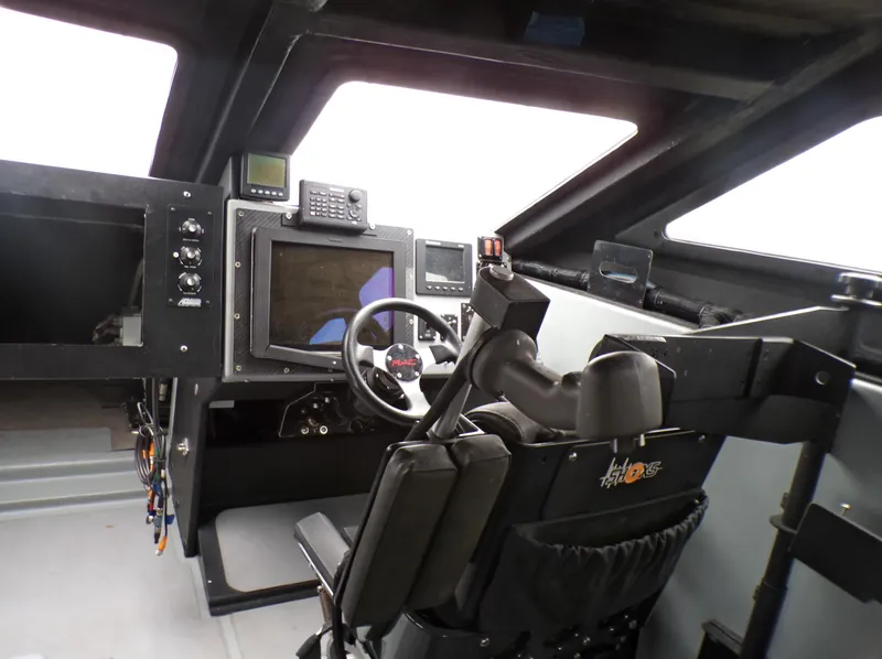 Slide: The Image of Cockpit of a 2001 Custom Revenge 50 boat with advanced navigation equipment. - 6