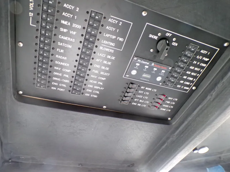 Slide: The Image of Electrical control panel of a 2001 Custom Revenge 50 boat, featuring various switches and labels. - 8