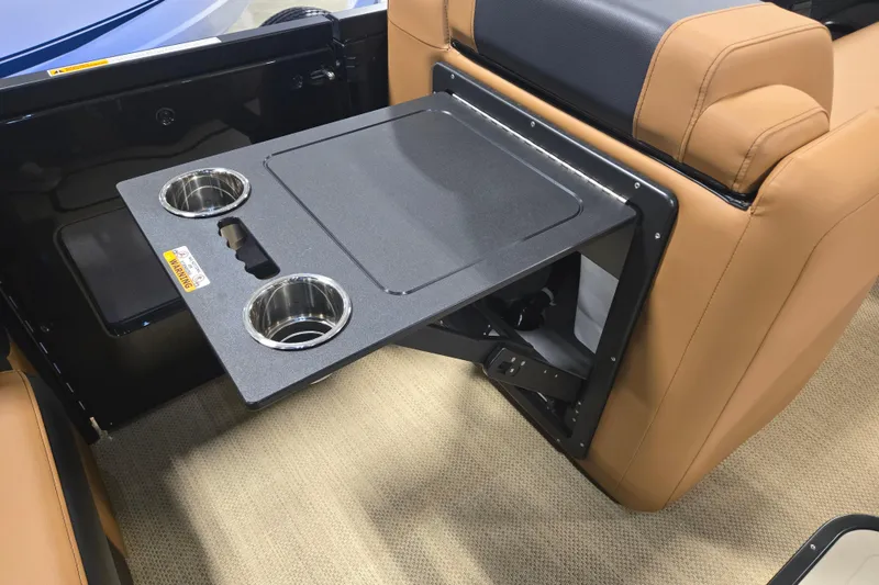Slide: The Image of 2025 Princecraft Vogue 25 RL boat interior with foldable table and cup holders. - 10