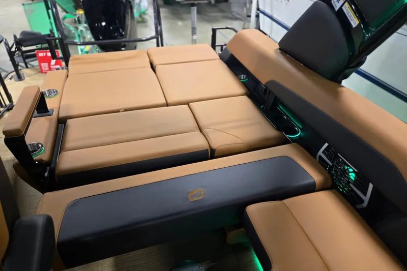 Slide: The Image of Luxurious seating on 2025 Princecraft Vogue 25 RL boat with tan upholstery and ambient lighting. - 13