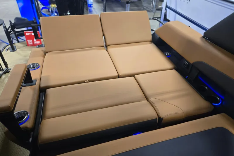Slide: The Image of Luxurious seating on 2025 Princecraft Vogue 25 RL boat with tan upholstery and cup holders. - 14
