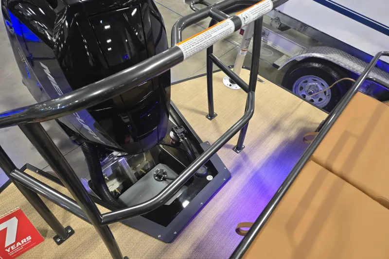Slide: The Image of 2025 Princecraft Vogue 25 RL boat engine area with safety railing and seating. - 17