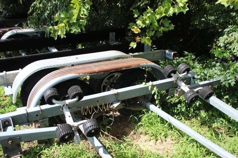 Slide: The Image of Boat trailer for 1998 Sea Ray 210 Sundeck, surrounded by greenery. - 26