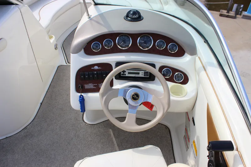 Slide: The Image of Cockpit of 1998 Sea Ray 210 Sundeck with steering wheel and instrument panel. - 10