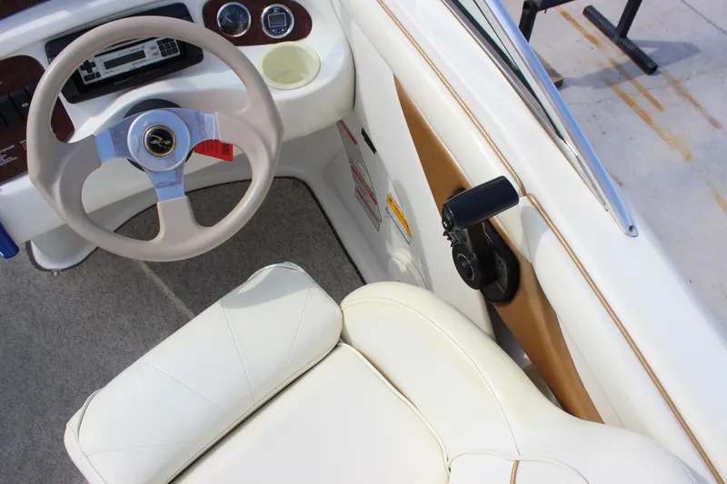 Slide: The Image of 1998 Sea Ray 210 Sundeck interior with steering wheel and dashboard controls. - 11