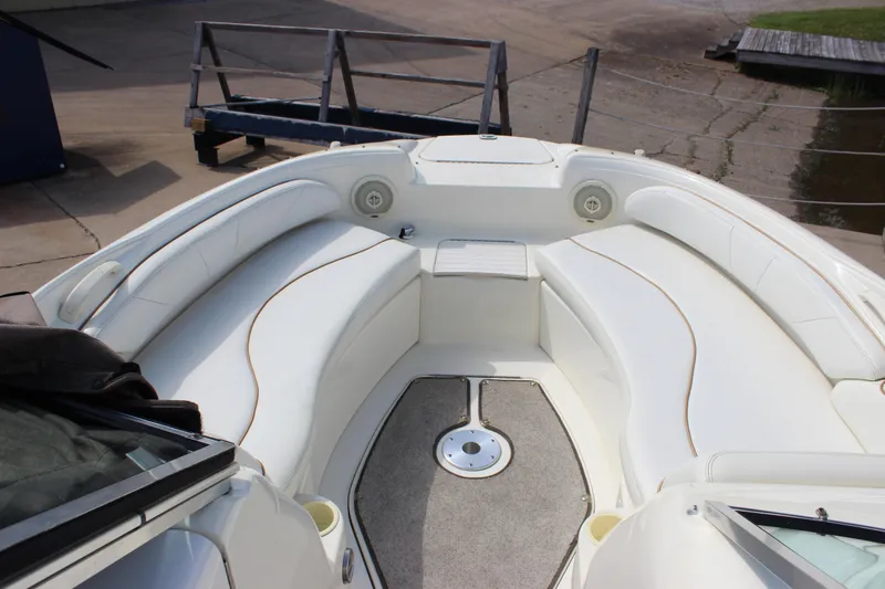 Slide: The Image of 1998 Sea Ray 210 Sundeck boat interior with white seating and carpeted floor. - 15