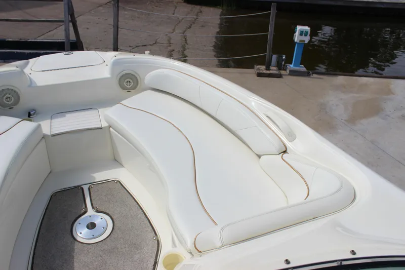 Slide: The Image of 1998 Sea Ray 210 Sundeck boat interior with white seating and speakers. - 16