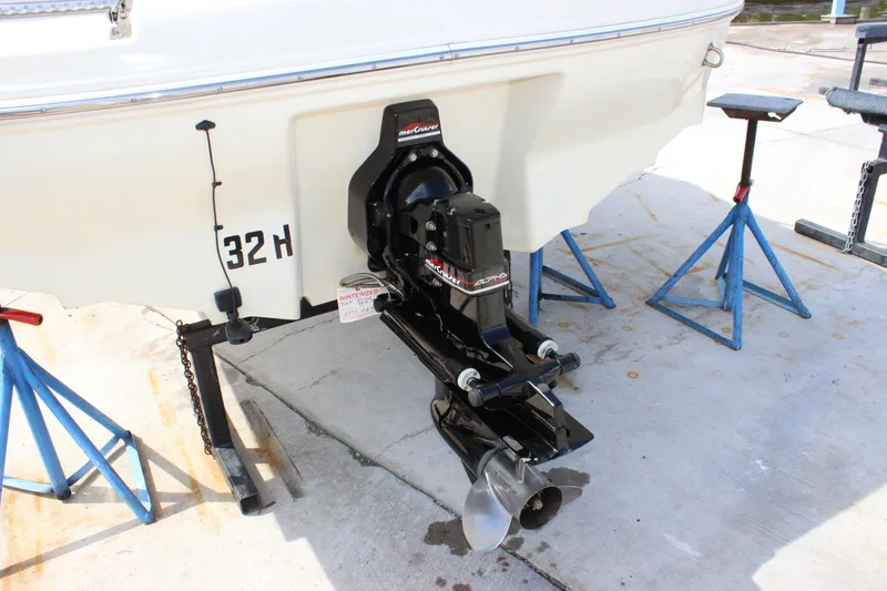 Slide: The Image of 1998 Sea Ray 210 Sundeck boat on stands, showing outboard motor and propeller. - 22