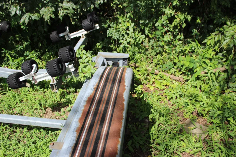 Slide: The Image of Boat trailer for 1998 Sea Ray 210 Sundeck amidst lush greenery. - 29