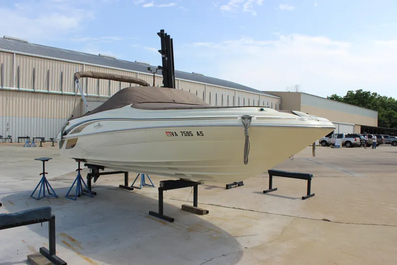 Slide: The Image of 1998 Sea Ray 210 Sundeck boat on stands in a marina yard. - 5