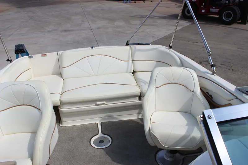 Slide: The Image of 1998 Sea Ray 210 Sundeck boat interior with white seating and carpeted floor. - 7