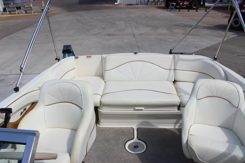 Slide: The Image of 1998 Sea Ray 210 Sundeck interior with white seating and open deck layout. - 8