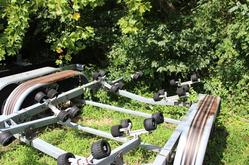 Slide: The Image of Boat trailer for 1998 Sea Ray 210 Sundeck surrounded by greenery. - 24