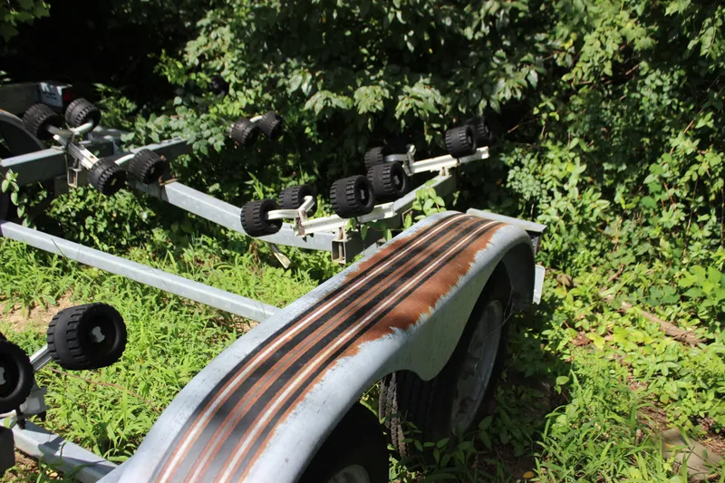 Slide: The Image of Boat trailer for 1998 Sea Ray 210 Sundeck surrounded by greenery. - 30