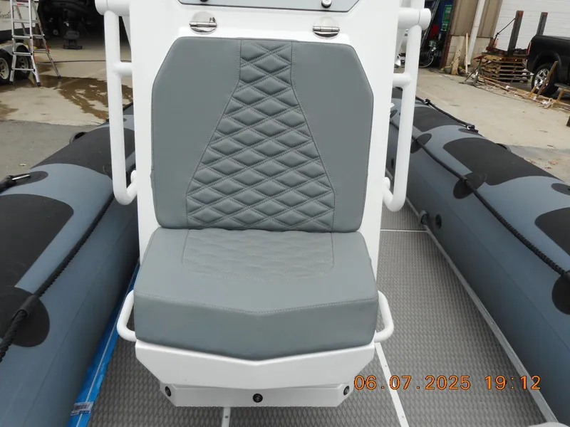 Slide: The Image of Highfield Patrol 540 boat seat, 2025 model, featuring gray diamond-pattern upholstery. - 10